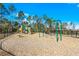 Community playground featuring swings, slides, and other outdoor play equipment for the Gathering at 314 Rover Rd, Ormond Beach, FL 32174