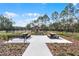 Community area with picnic tables, benches, and a playground in a park-like setting at 314 Rover Rd, Ormond Beach, FL 32174