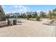 Community pool area with lounge chairs, tables, umbrellas, and a view of the surrounding trees at 314 Rover Rd, Ormond Beach, FL 32174