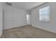 Bright bedroom featuring neutral carpeting and a window with blinds at 555 Orient Ave, Debary, FL 32713