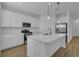 Modern kitchen featuring white cabinets, an island, and stainless steel appliances at 555 Orient Ave, Debary, FL 32713