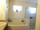 Relaxing bathroom with a soaking tub and a glass-enclosed shower at 721 Willow Run St, Minneola, FL 34715