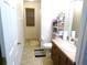 Narrow bathroom featuring a sink vanity, toilet, and shower/tub combo at 721 Willow Run St, Minneola, FL 34715