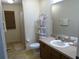 Bathroom featuring vanity with a single sink and a shower with a curtain at 721 Willow Run St, Minneola, FL 34715