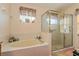 Bathroom featuring a soaking tub and a glass-enclosed shower at 721 Willow Run St, Minneola, FL 34715