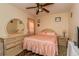 Bedroom with a large dresser, bedside table, and mirror at 721 Willow Run St, Minneola, FL 34715