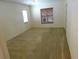 Bright bedroom featuring neutral carpet, large windows, and ample natural light at 721 Willow Run St, Minneola, FL 34715