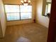 Charming dining room featuring carpet flooring, chandelier and large bright window at 721 Willow Run St, Minneola, FL 34715