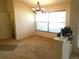 Charming dining room featuring carpet flooring, chandelier and large bright window at 721 Willow Run St, Minneola, FL 34715