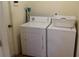 Laundry room with a washing machine, dryer, ironing board and laundry basket at 721 Willow Run St, Minneola, FL 34715