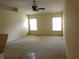 Spacious living room with two bright windows and neutral walls, offering versatile design options at 721 Willow Run St, Minneola, FL 34715