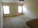 Spacious living room with two bright windows and neutral walls, offering versatile design options at 721 Willow Run St, Minneola, FL 34715