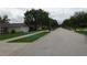 Quiet residential street view with well-maintained lawns and mature trees at 721 Willow Run St, Minneola, FL 34715