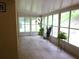 Bright sunroom filled with natural light from large windows and neutral tile flooring at 721 Willow Run St, Minneola, FL 34715