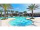 Resort-style pool with palm trees and comfortable seating, perfect for relaxation and recreation at 17608 Saw Palmetto Ave, Clermont, FL 34714