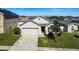 House exterior featuring a two-car garage and well-manicured lawn at 356 Nova Dr, Davenport, FL 33837