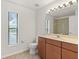 Well-lit bathroom with a vanity sink, a large mirror, and tile floors at 36711 Alaqua Ct, Eustis, FL 32736