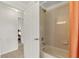 Small bathroom with shower/tub and peach colored shower curtain at 36711 Alaqua Ct, Eustis, FL 32736