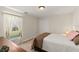 Well lit bedroom with a large window and closet; neutral walls and carpet at 36711 Alaqua Ct, Eustis, FL 32736