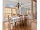 Dining room features wood floors, a large table, and a large window at 36711 Alaqua Ct, Eustis, FL 32736