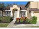 Front entrance with columns and landscaping at 36711 Alaqua Ct, Eustis, FL 32736