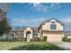 Charming two-story home featuring a manicured lawn, colorful landscaping, and an attached two-car garage at 36711 Alaqua Ct, Eustis, FL 32736