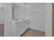 Double vanity bathroom with white cabinets and a large mirror at 438 Belmond Dr, Debary, FL 32713