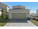 Attached garage with light beige door and brick paver driveway at 438 Belmond Dr, Debary, FL 32713