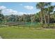 Serene lake view with a wooden dock and lush greenery at 438 Belmond Dr, Debary, FL 32713