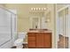 Cozy bathroom with a combined shower and tub, a vanity with good lighting, and a toilet at 4538 Nottoway Dr, Leesburg, FL 34748