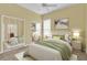 Bright bedroom with mirrored closet doors, neutral tones, and ample natural light at 4538 Nottoway Dr, Leesburg, FL 34748