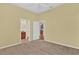 Neutral bedroom with doorways leading to the bathroom and other areas of the home at 4538 Nottoway Dr, Leesburg, FL 34748