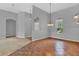 Open dining room with tile floors, stylish lighting, and adjacent rooms at 4538 Nottoway Dr, Leesburg, FL 34748