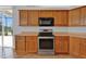 Kitchen featuring wood cabinets, stainless steel appliances, and countertop space at 4538 Nottoway Dr, Leesburg, FL 34748