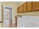 Laundry room with a washing machine, dryer, sink, and ample cabinet space at 4538 Nottoway Dr, Leesburg, FL 34748