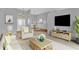 Comfortable living room with neutral tones, plush seating, and dining area at 4538 Nottoway Dr, Leesburg, FL 34748