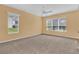 Bright living room with large windows offering scenic views and neutral walls at 4538 Nottoway Dr, Leesburg, FL 34748