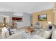 Comfortable living room with neutral tones, plush seating, and dining area at 4538 Nottoway Dr, Leesburg, FL 34748