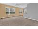 Open-concept living room with large windows, ample natural light, and seamless flooring at 4538 Nottoway Dr, Leesburg, FL 34748