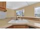 Close-up of kitchen sink with faucet and window overlooking outdoor view at 4538 Nottoway Dr, Leesburg, FL 34748