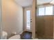 A light and airy bathroom, featuring a glass shower door and back door to the outside at 4916 Fiji Cir # 11, Orlando, FL 32808