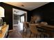 Dining room with black accent walls and a view into the living room with stone fireplace at 4916 Fiji Cir # 11, Orlando, FL 32808