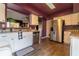 Well-lit kitchen with stainless steel appliances, granite countertops, white cabinets, and wood-look flooring at 4916 Fiji Cir # 11, Orlando, FL 32808