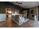 Inviting living room featuring wood-look flooring, a stone fireplace, and an open view into the kitchen at 4916 Fiji Cir # 11, Orlando, FL 32808