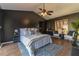 Main bedroom with tray ceiling, dark accent wall, neutral furnishings and wood-look floors at 4916 Fiji Cir # 11, Orlando, FL 32808