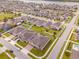 Expansive aerial view showcasing a meticulously planned community, a serene lake, and lush green landscaping at 1518 Alligator St, St Cloud, FL 34771