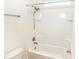Clean, white bathroom with a shower-tub combination with tile surround and chrome fixtures at 1518 Alligator St, St Cloud, FL 34771