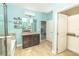 Well-lit bathroom features double granite vanity, a tiled shower and tub, and blue accent walls at 1518 Alligator St, St Cloud, FL 34771