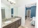 The bathroom features double sinks with granite counters and access to the bedroom at 1518 Alligator St, St Cloud, FL 34771