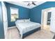 The modern bedroom features a ceiling fan, blue accent wall, and an ensuite bathroom at 1518 Alligator St, St Cloud, FL 34771